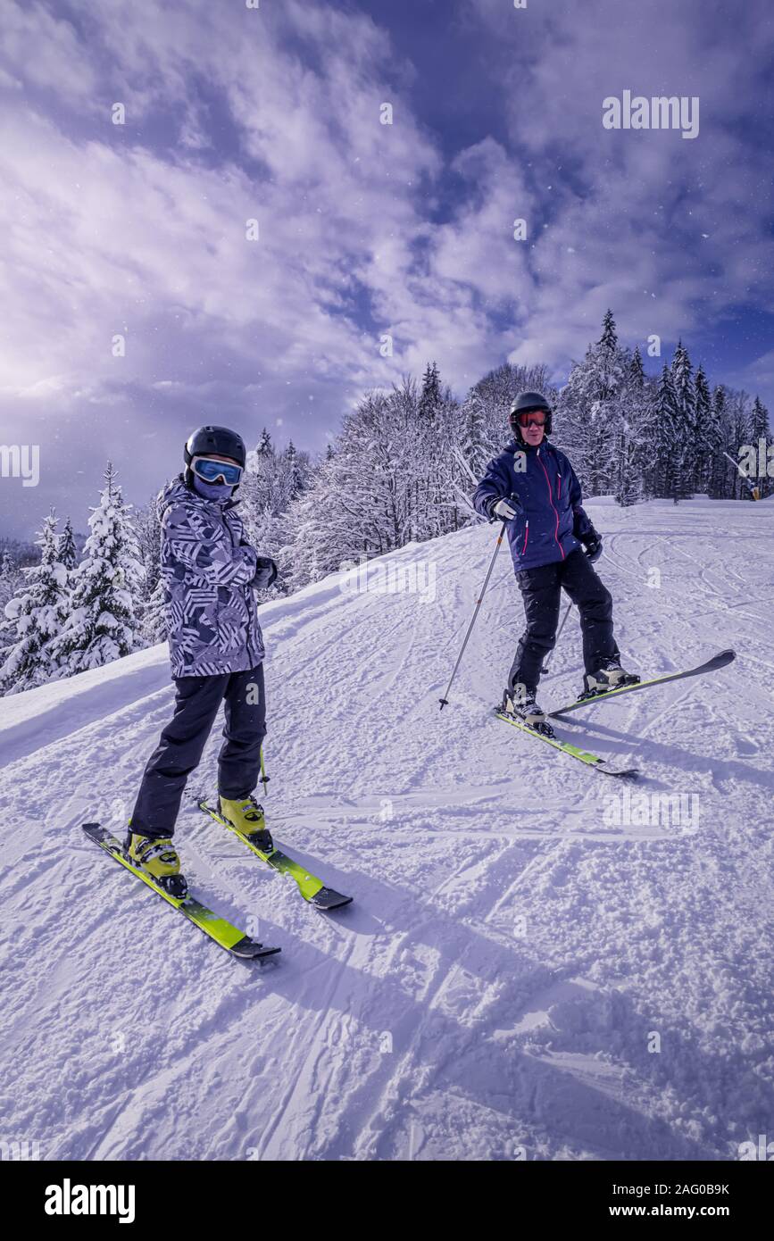 Familie ist Spaß in Skiausrüstung am Berghang. Vater und Sohn sind ihre Zeit zusammen genießen. Sonnenschein und Schnee zur gleichen Zeit. Acti Stockfoto