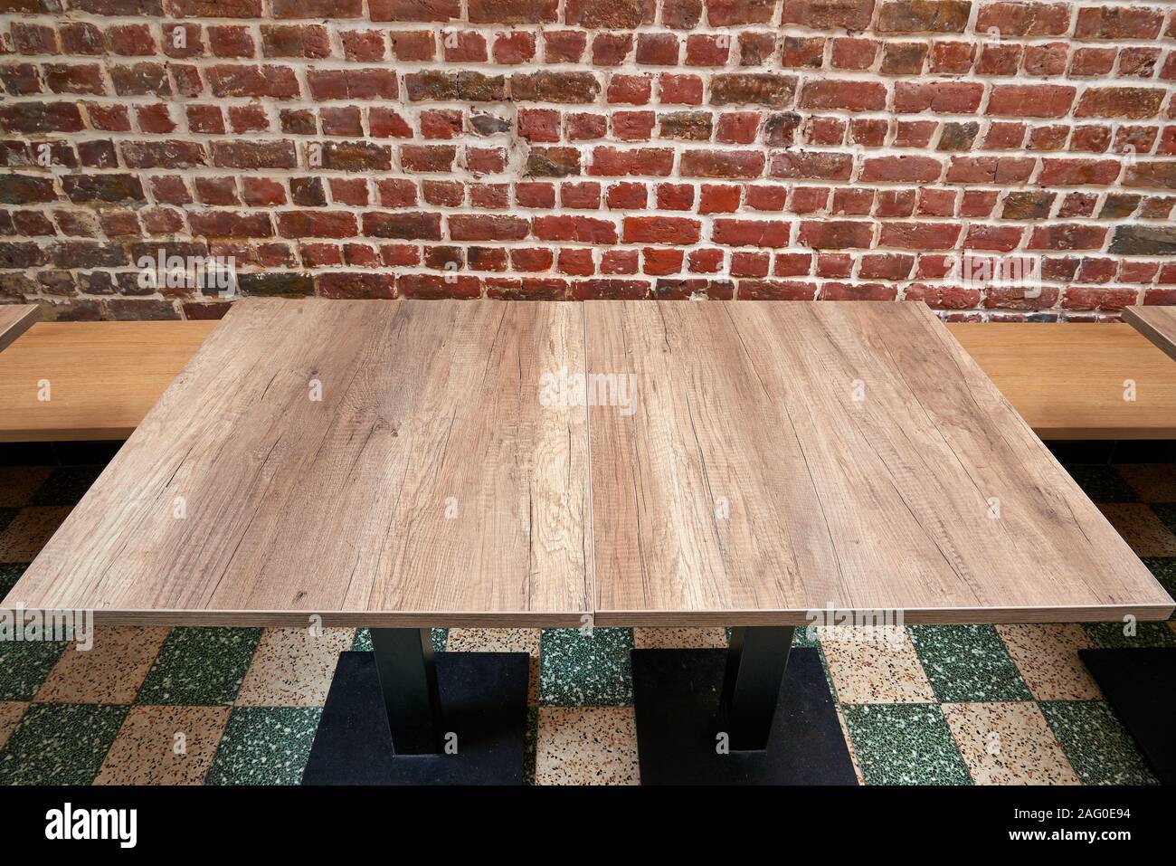 Schönen rustikalen Holztisch gegen Red brick wall Stockfoto