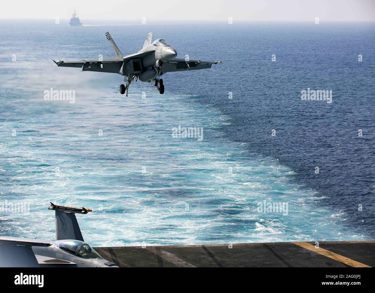 Ein U.S. Navy F/A-18E Super Hornet Kampfflugzeuge der Faust der Flotte von Strike Fighter Squadron 25 angebracht, Ansätze für die Landung auf dem Flugdeck der Nimitz-Klasse Flugzeugträger USS Abraham Lincoln zur Unterstützung der Operation inhärenten Lösen Dezember 10, 2019 in den Arabischen Golf. Stockfoto