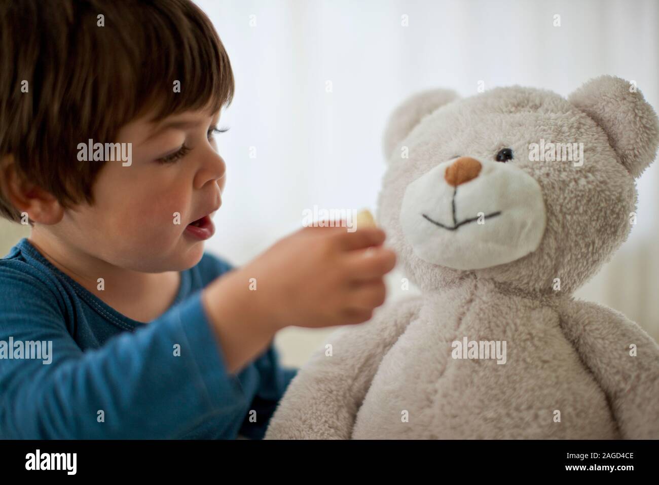 Junge Junge spielt mit seinem Teddybären. Stockfoto
