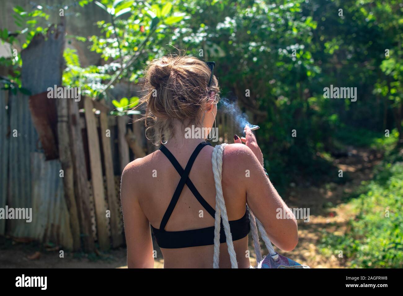 Frau raucht einen gemeinsamen Schuss von hinten Stockfoto