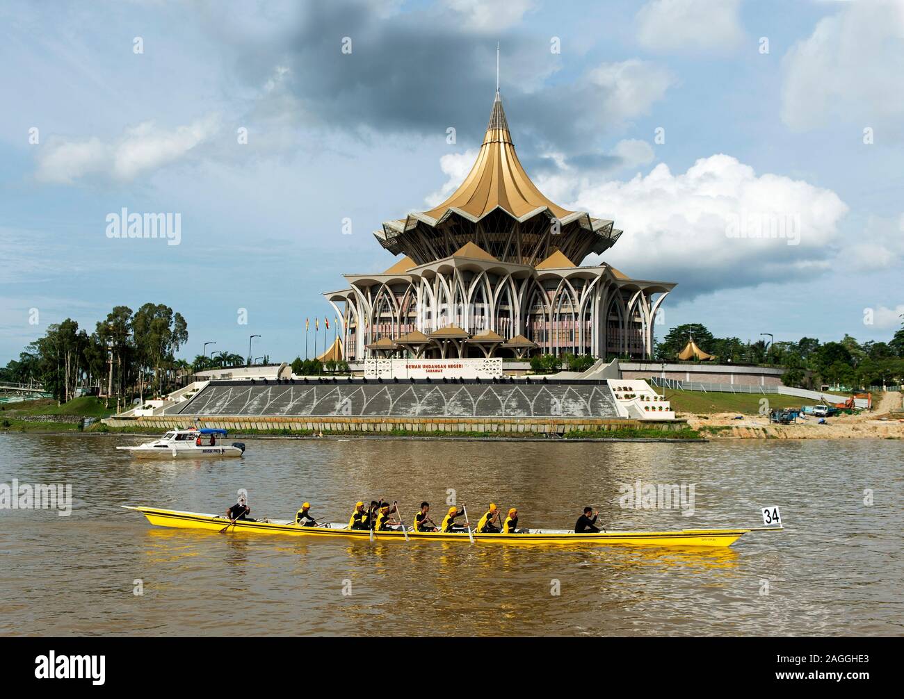 Longboat durch die gesetzgebende Versammlung von Sarawak Gebäude, durch den Fluss Sarawak, Kuching, Sarawak, Borneo, Malaysia Stockfoto
