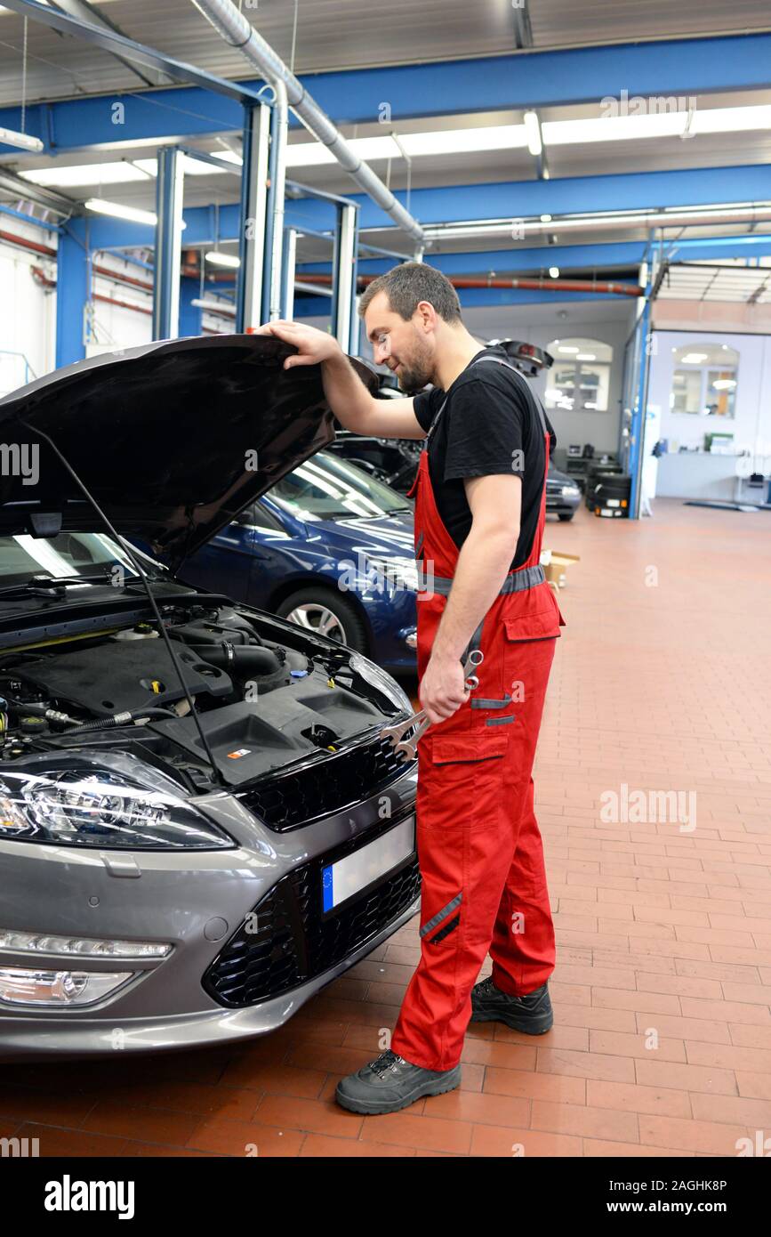 Job und Arbeitsplatz - Mechaniker in einer Werkstatt die Reparatur eines Autos Stockfoto