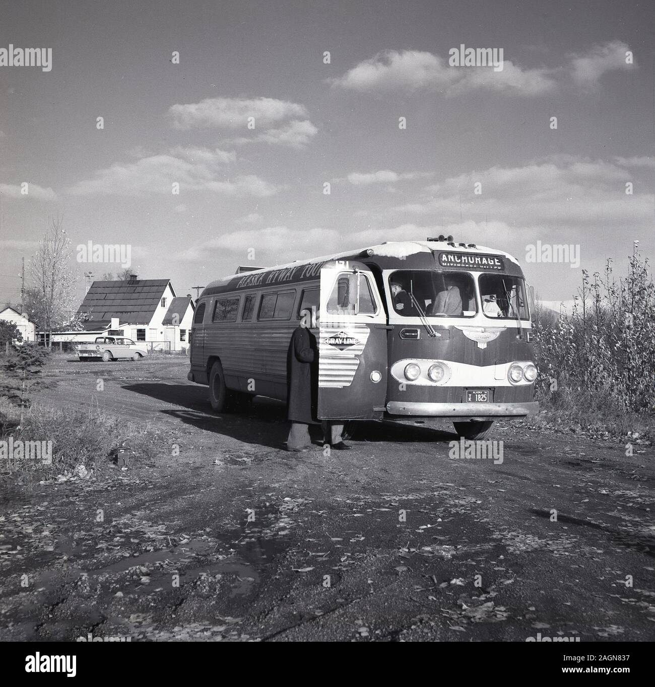1960er Jahre, historisch, draußen auf einer Schotterpiste, Erwachsene Passagiere in einem Gray-Line Sightseeing oder Ausflugsbus nach Anchorage, Alaska, USA. Stockfoto