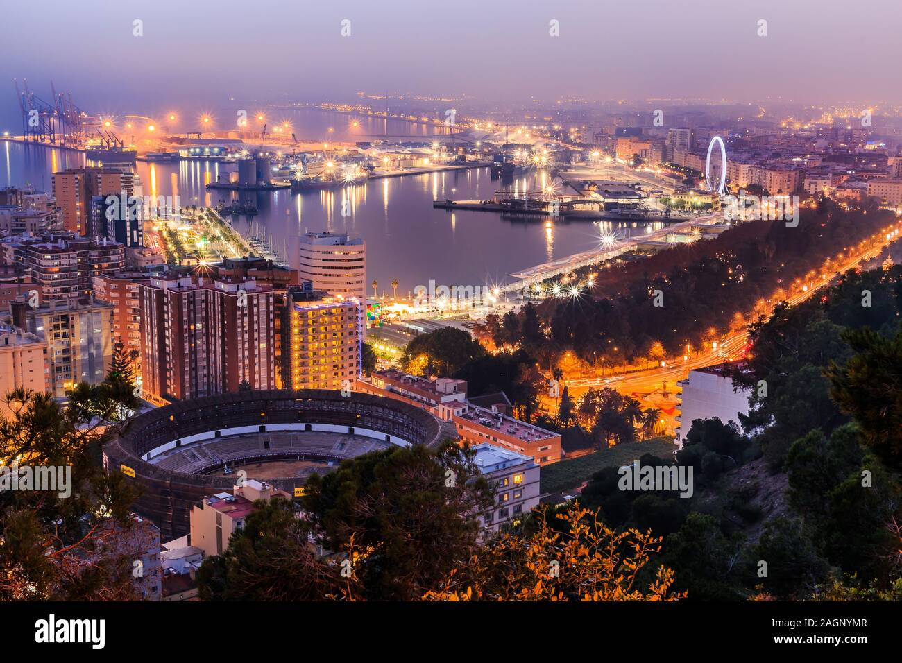 Panoramaaussicht in der Nacht von Málaga an der spanischen Mittelmeerküste. Blick auf die Stadt an der Costa del Sol mit beleuchteten Hafen, Wohngebäude Stockfoto