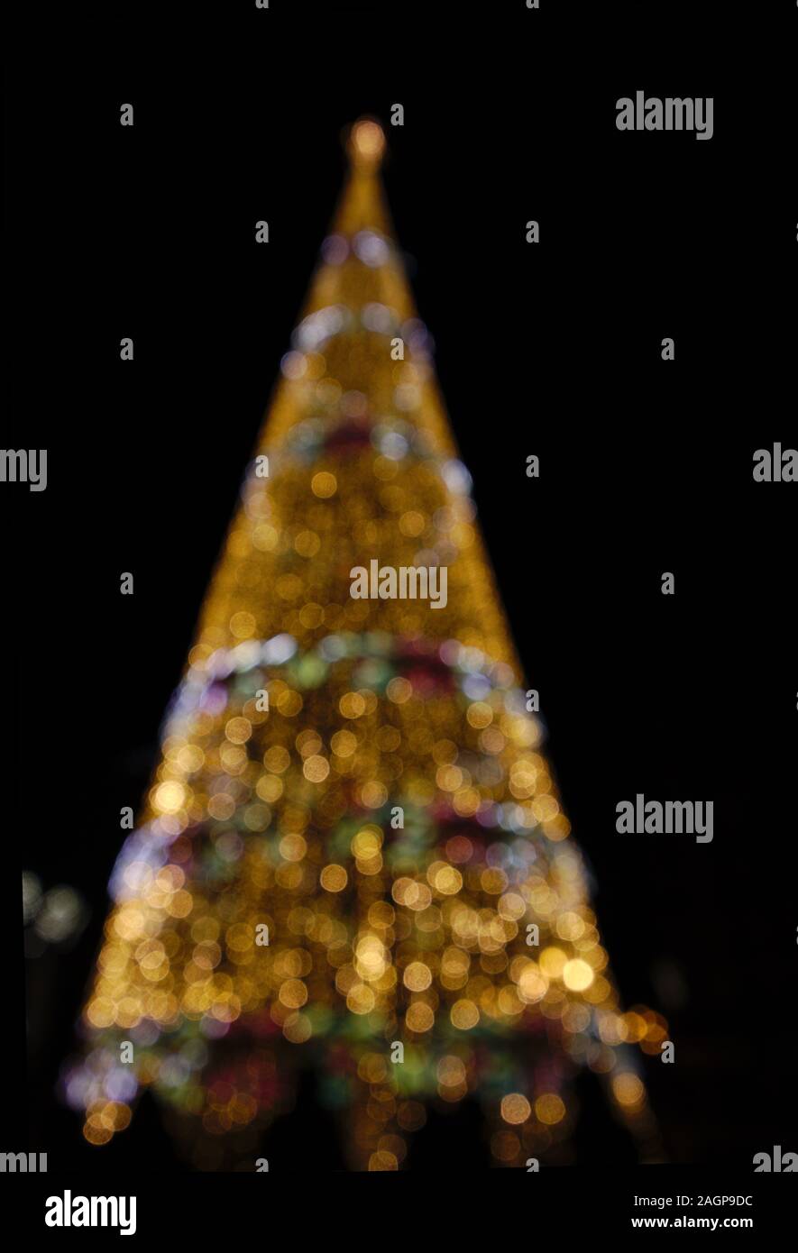 Defokussierten Weihnachtsbaumbeleuchtungen Kontrast mit der Dunkelheit der Nacht Stockfoto