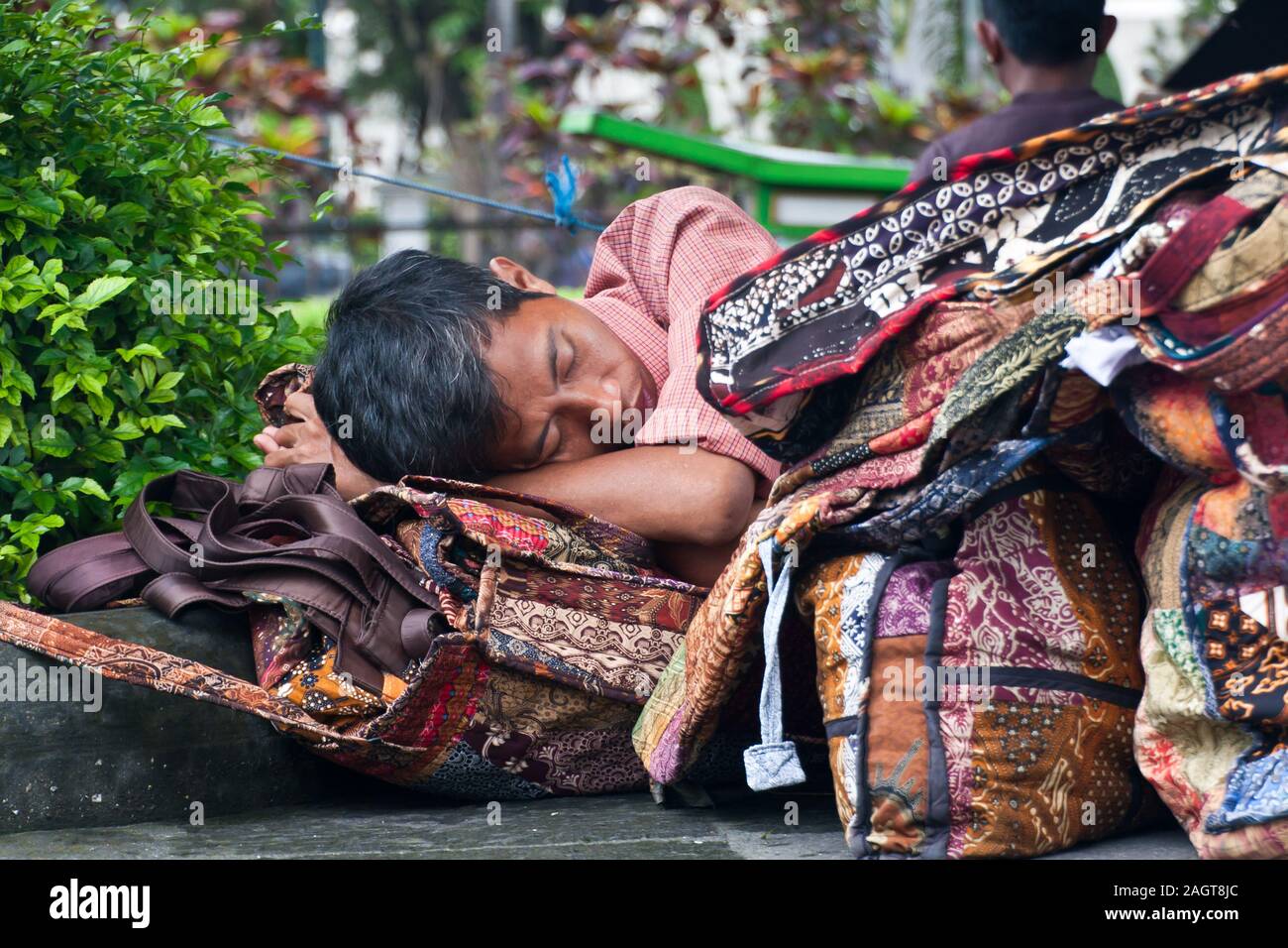 Ein Mann, der auf der Straße von Yogyakarta, Indonesien, schläft Stockfoto