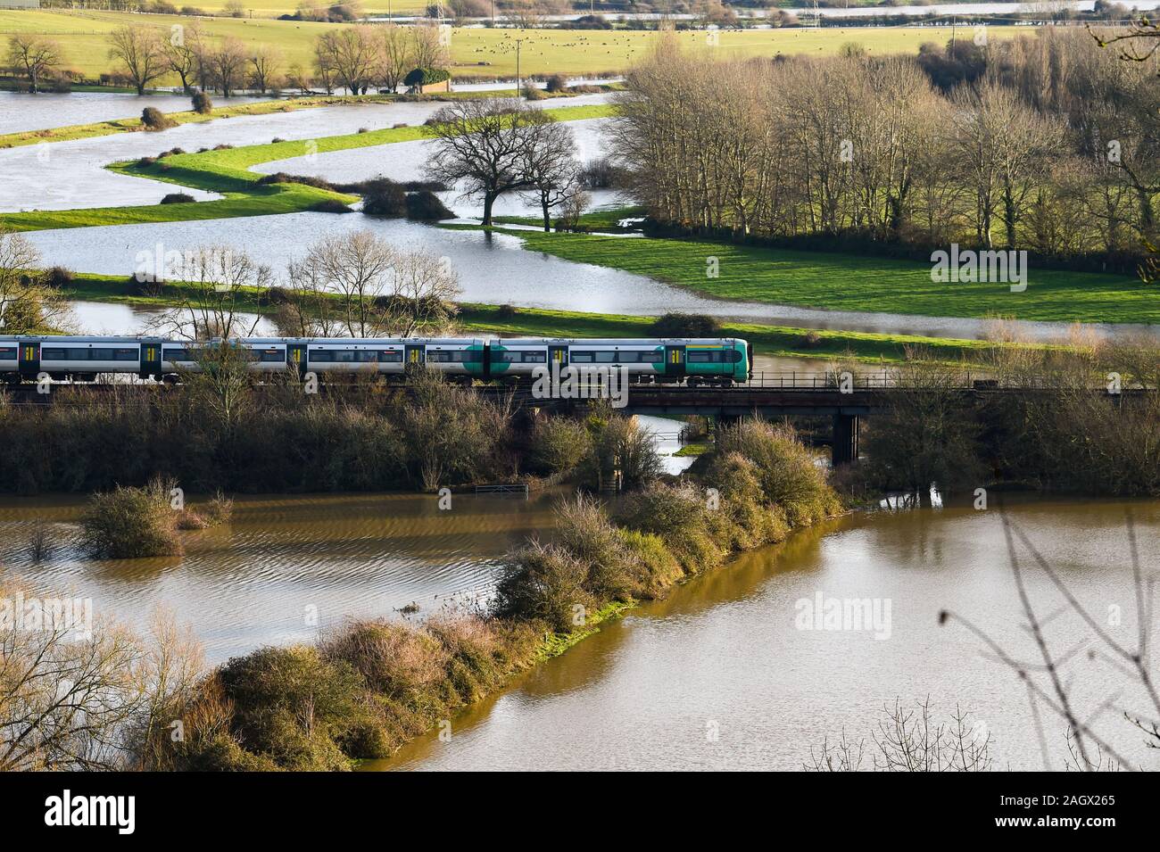 Lewes Großbritannien 22. Dezember 2019 - ein Zug fährt über gefluteten Feldern nördlich von Lewes in East Sussex Nach dem nächtlichen Regen mehr Wetter- und Hochwasserwarnungen über Großbritannien nach Tagen der ständige Regen erteilt wurden: Credit Simon Dack/Alamy leben Nachrichten Stockfoto