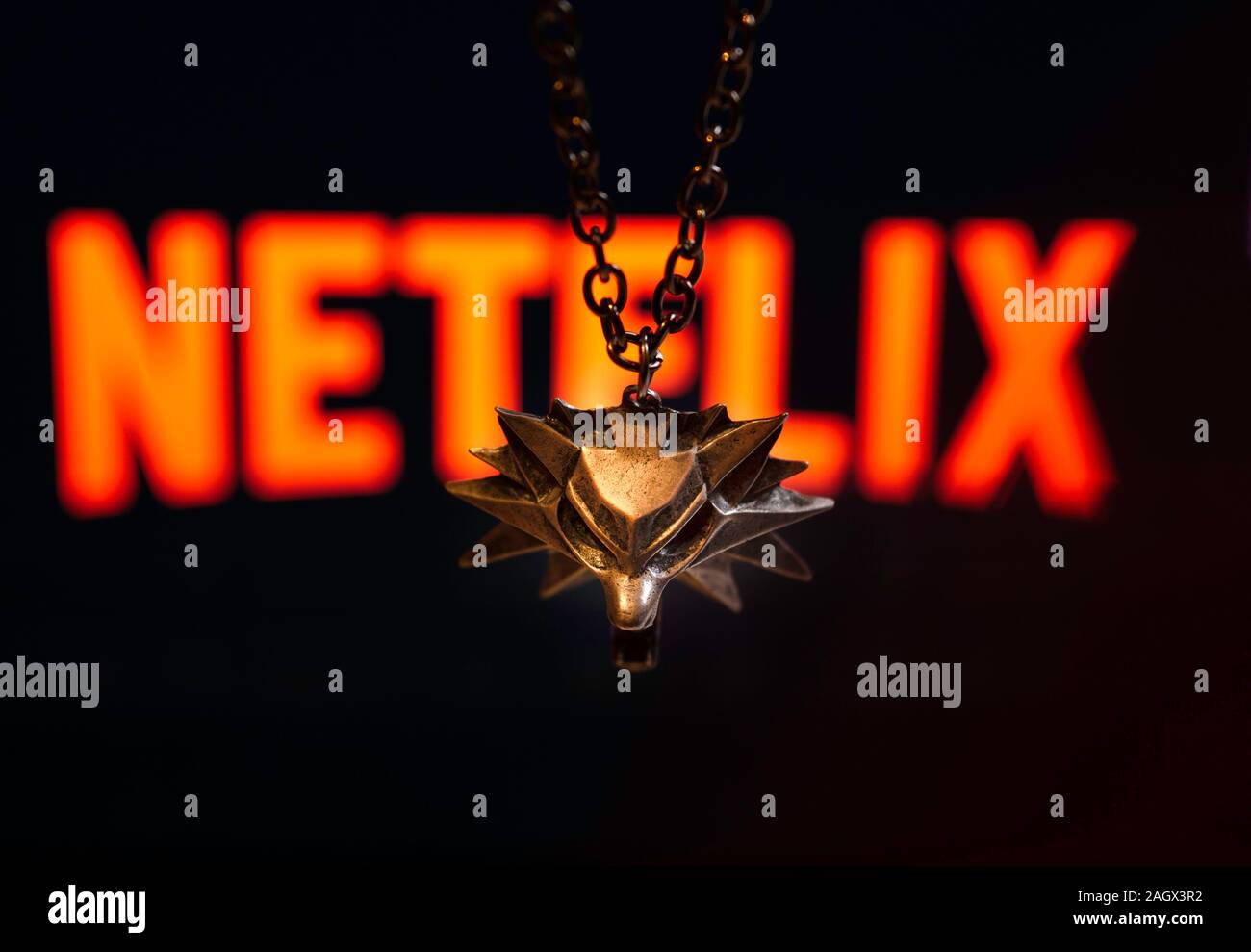 NIZHYN, UKRAINE / 21 Dezember 2019: Geralt Medaillon in Form von Wolf mit Netflix Logo auf Hintergrund. Neue TV-Serie "The Witcher" Premiere Konzept Stockfoto