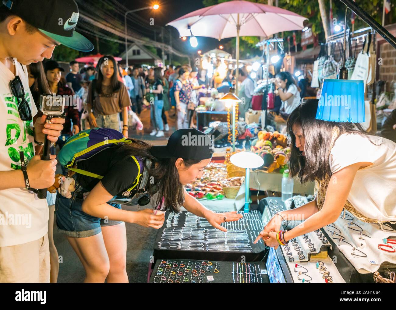 Chiang Mai, Thailand - Dezember 5, 2017: Junge asiatische Touristen Schmuck bei der Saturday Night Bazaar wählen. Ein traditioneller Markt jede Woche in Chiang Mai, Nordthailand. Stockfoto