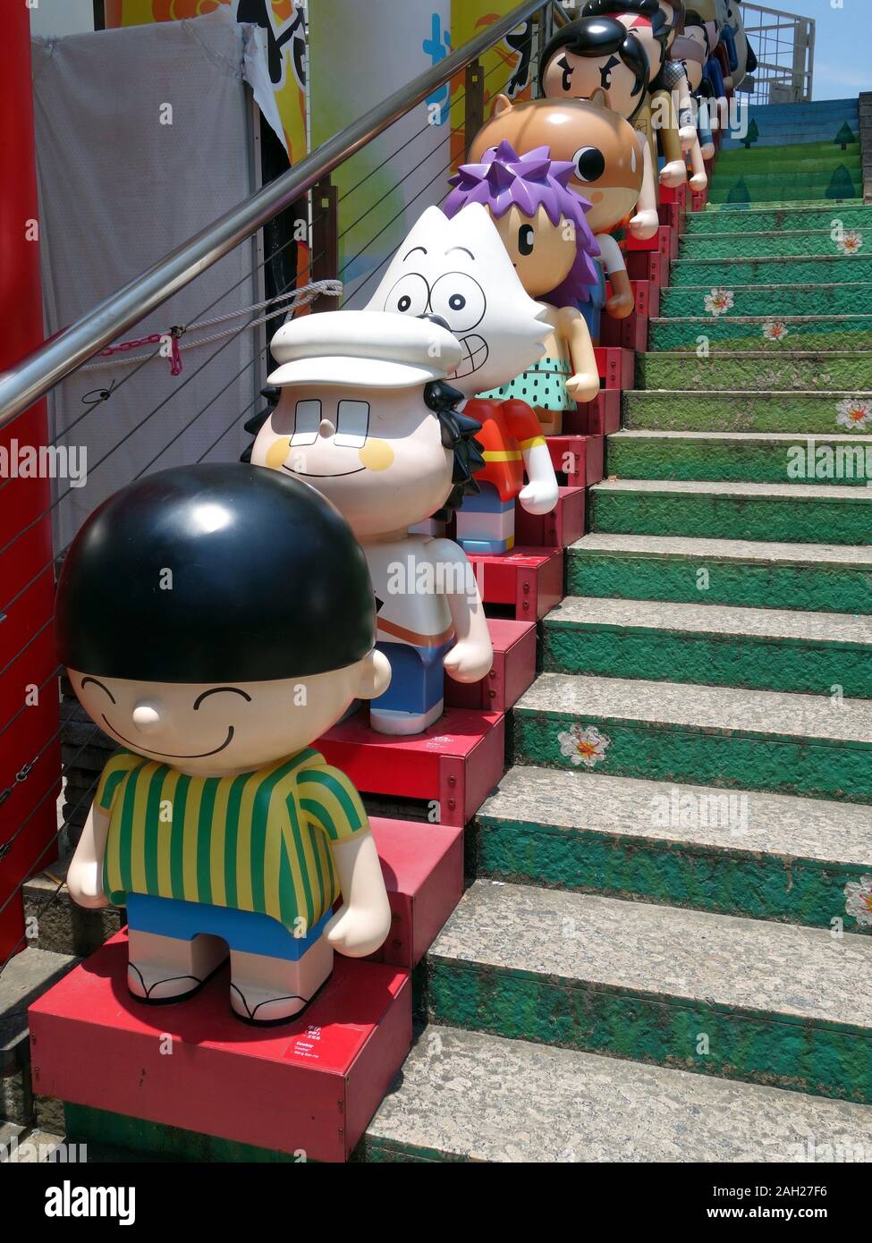 Sieben Zeichentrickfiguren aufgereiht eine Treppe neben dem Kowloon Park. Stockfoto
