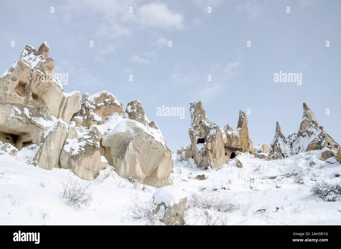 Panorama der einzigartigen geologischen Felsformationen unter Schnee in Kappadokien, Türkei. Stockfoto