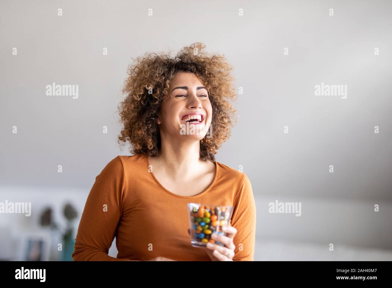 Lächelnd Mitte der erwachsenen Frau essen ein Cookie Stockfoto
