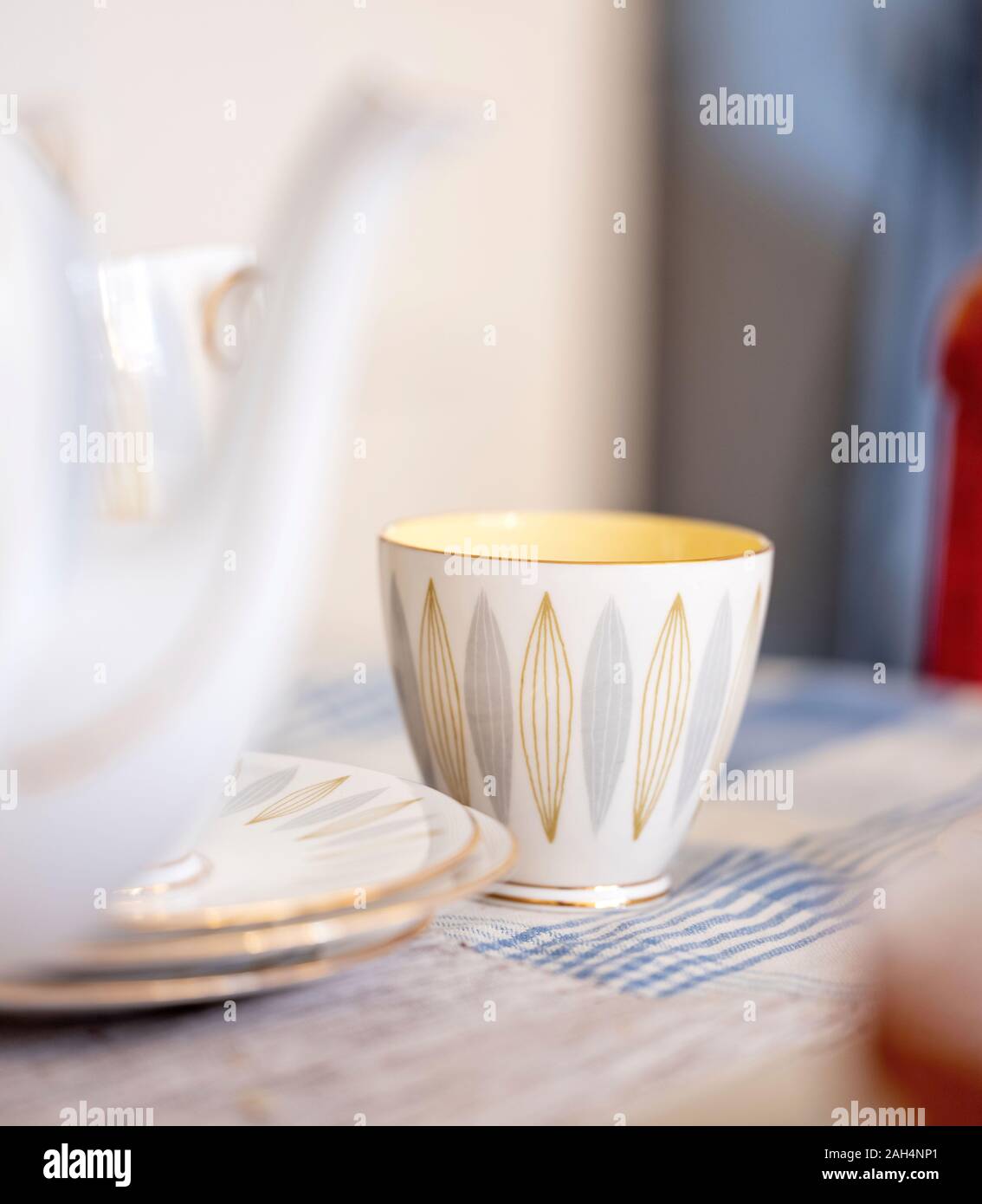 Ein farbiges Licht Vintage Tee Tasse auf einem Küchentisch. Stockfoto