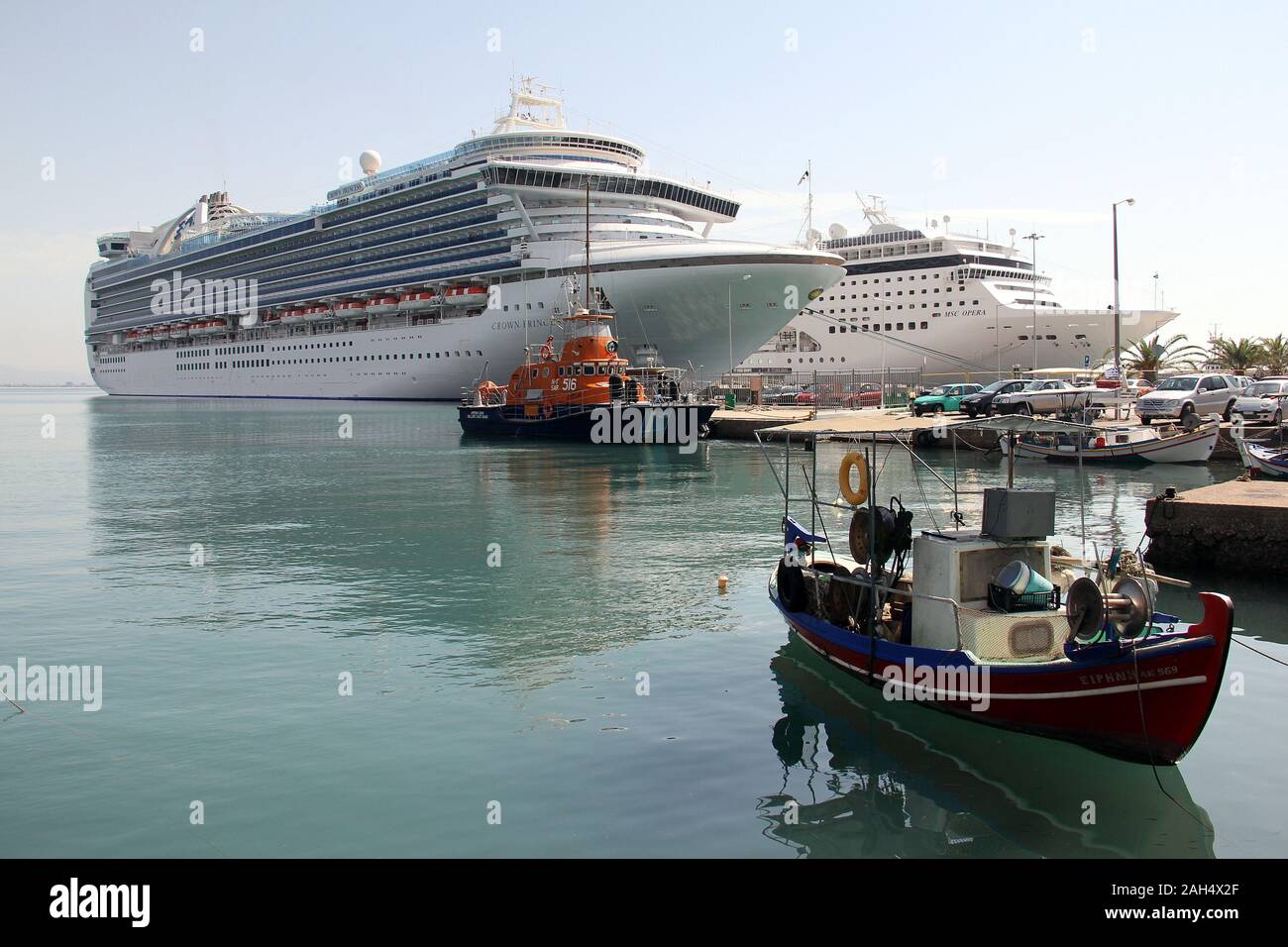 Kreuzfahrtschiffe und einem alten rustikalen Fischerboot im Hafen Stockfoto