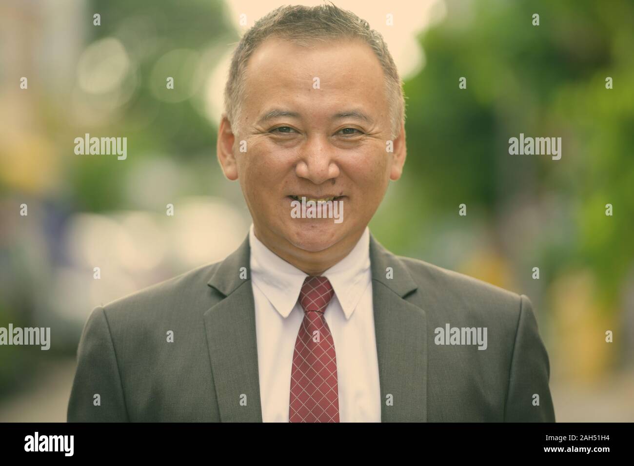Portrait von Reifen japanischen Geschäftsmann, der in den Straßen im Außenbereich Stockfoto
