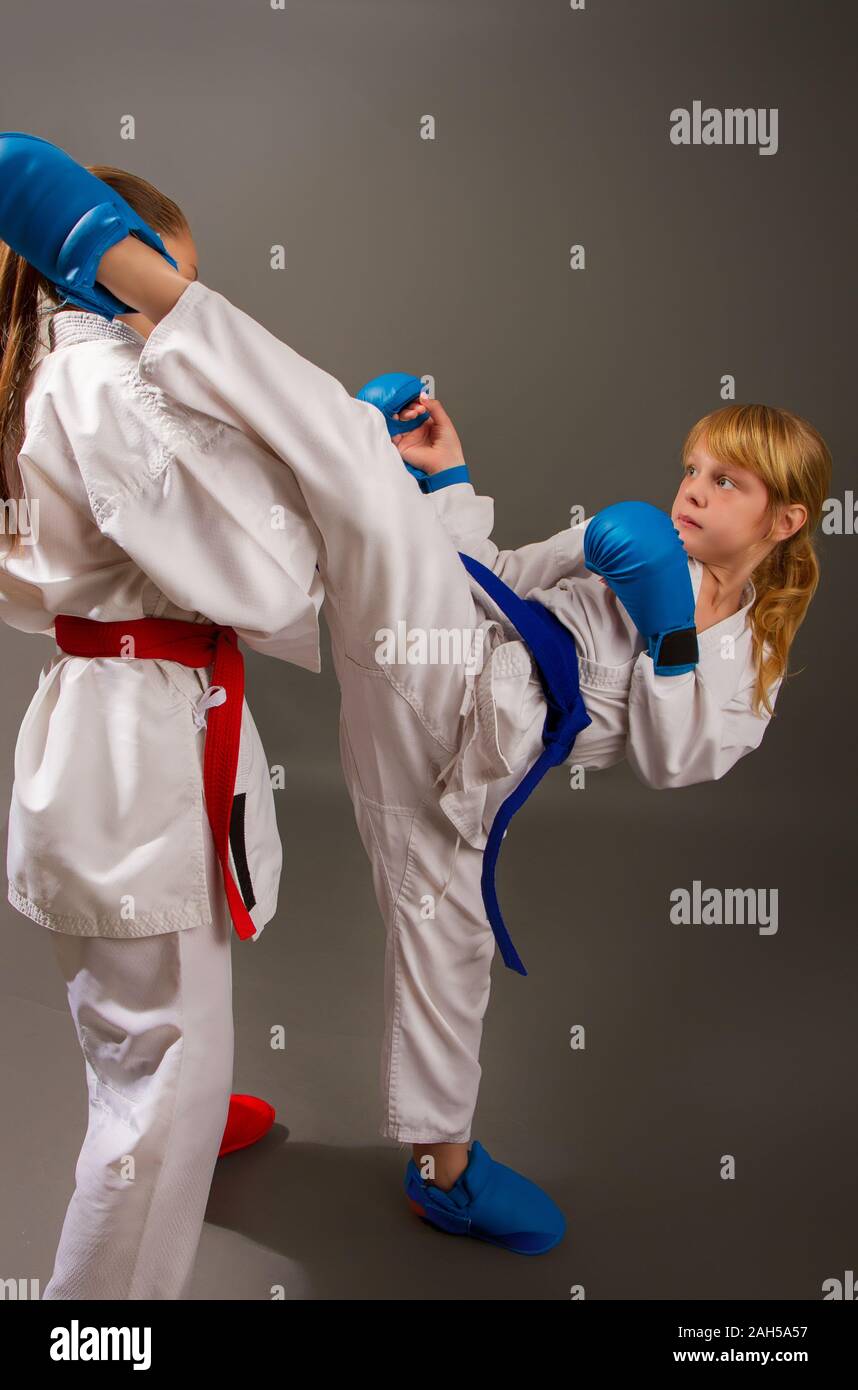 Sport Karate kämpfen zwei kleine Mädchen in weißen Kimono Rot eine Sekunde in Blau schützende Kits Stockfoto