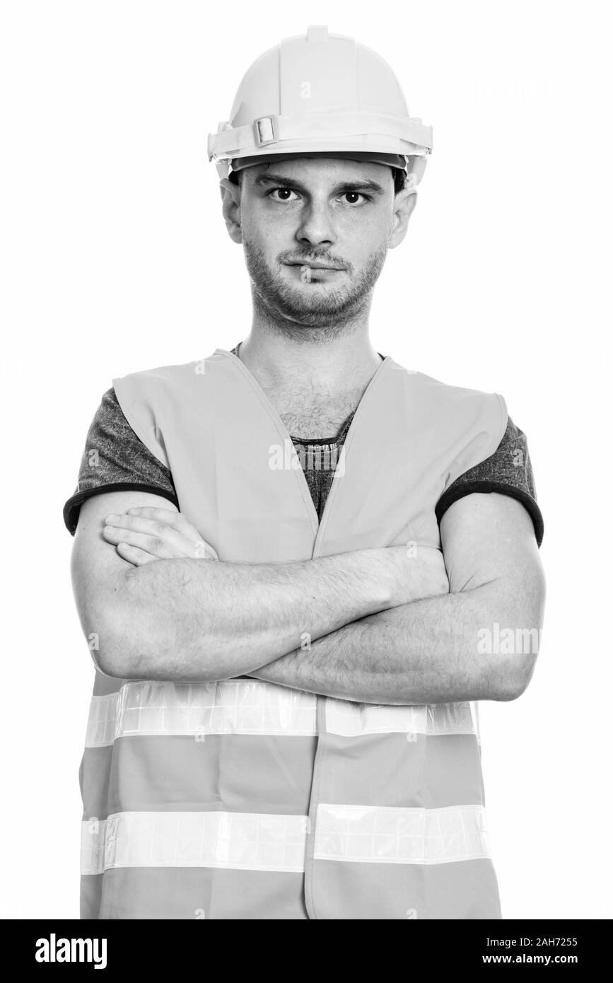 Studio shot des jungen Mannes Bauarbeiter mit verschränkten Armen Stockfoto