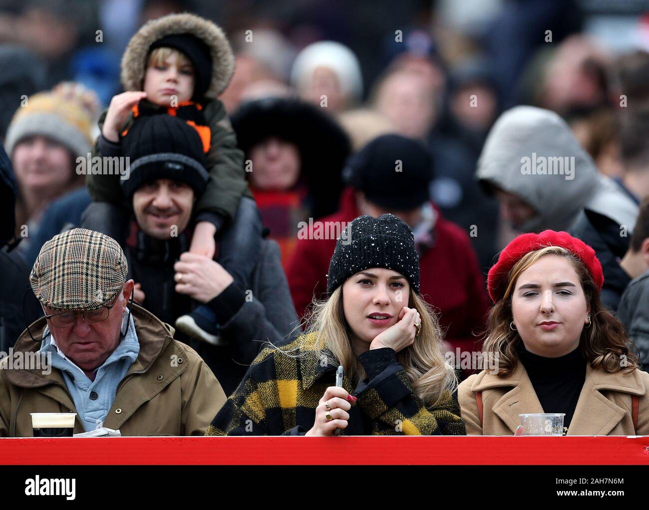 Rennen goers sehen die Aktion während des Tages eine Der Winter Festival in Kempton Park Racecourse. Stockfoto