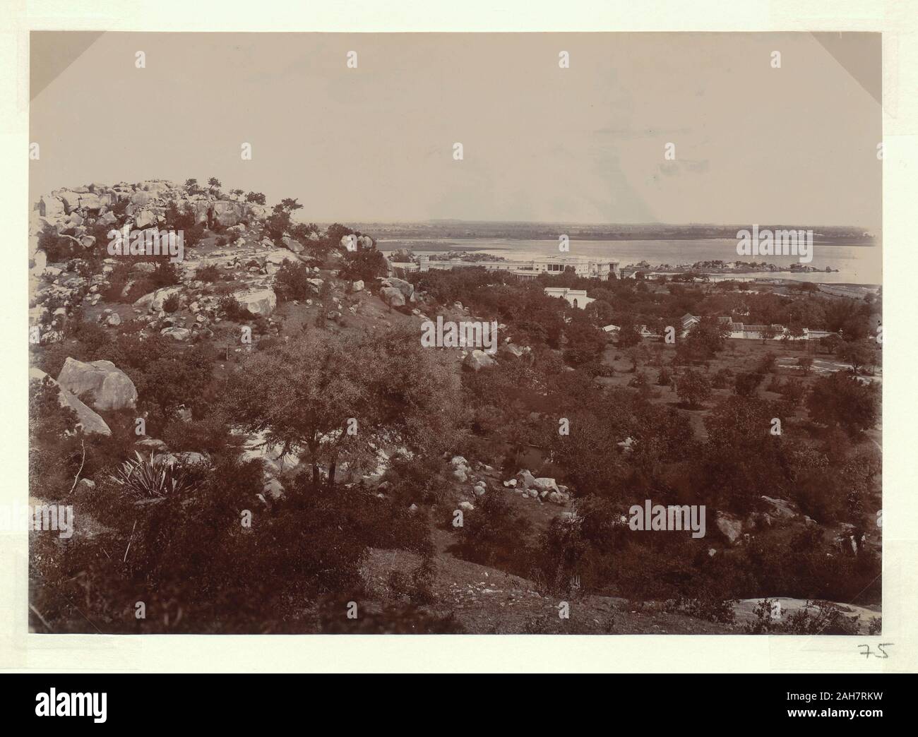 Indien, mit Blick auf ein großes, weißes Gebäude im Kolonialstil in der Nähe der Waterfront, von einem Felsvorsprung. Wahrscheinlich die Minze Compound in Hyderabad. Beschriftung auf der Rückseite: Blick von H.H.'s Minze aus schwarzen RocksRs 2/-, circa 1905. 2003/071/1/1/3/75. Stockfoto