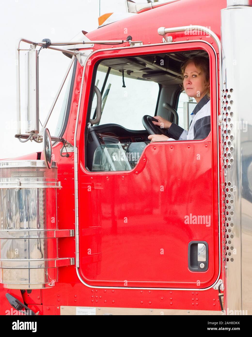 Frau LKW-Fahrer Blick aus dem Fenster während der Fahrt ein Big Rig Stockfoto