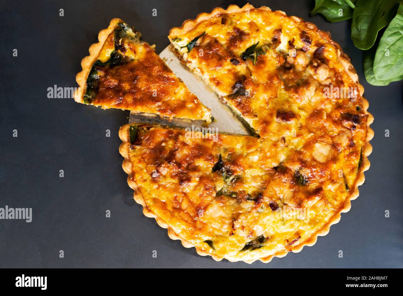 Ansicht von oben frisch backen Lauch quiche Speck Spinat auf dunklem Hintergrund Stockfoto