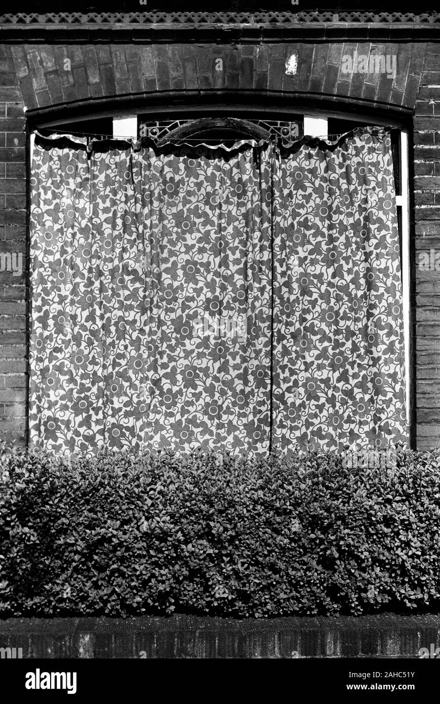 Außenansicht des Hauses mit Vorhang über das Fenster gezogen, um Schäden durch starkes Sonnenlicht zu verhindern. Die Fensterrahmen wurden kürzlich neu lackiert. Die Außenvorhänge sollen die neue Lackierung schützen. London 1971 1970s UK HOMER SYKES Stockfoto