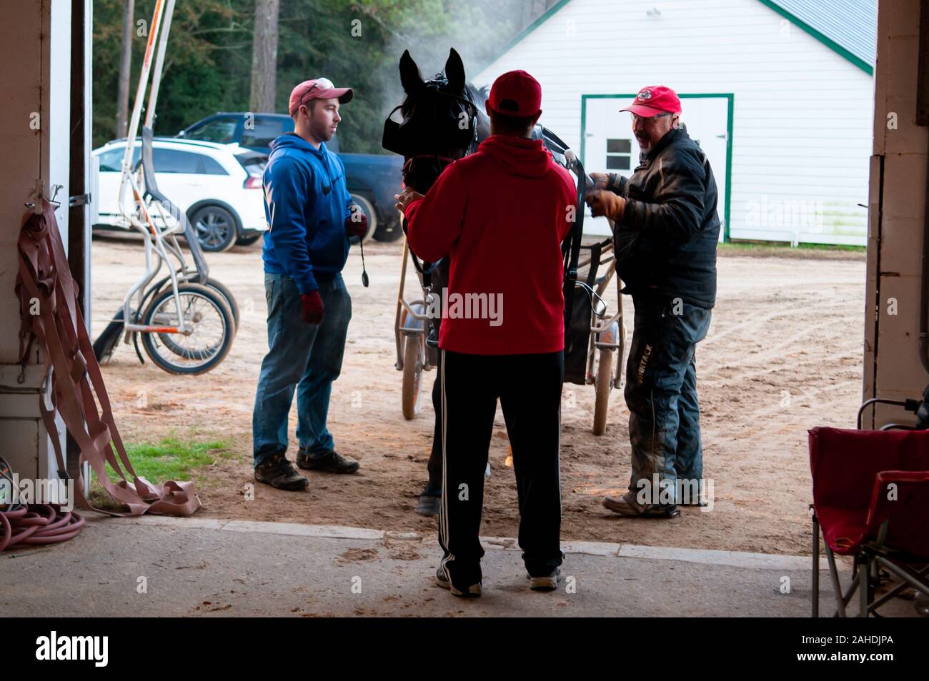 Pinehurst, North Carolina, USA. 28 Dez, 2019. Dez. 28, 2019 - Pinehurst, N.C., USA - JAY HOCHSTETLER, Links, MATT "Radar" TUMOLILLO, Mitte, und HOMER HOCHSTETLER ein Pferd auf die Hochstetler Racing Scheune zurück im Winter Training an der Pinehurst Fahren & Training Club, Pinehurst Kabelbaum Track, Pinehurst, North Carolina. Homer Hochstetler Rennställe ist eine von vielen Kabelbaum Rennfahrer aus der NortheastU. S., die zu Pinehurst für das Wintertraining. Credit: Timothy L. Hale/ZUMA Draht/Alamy leben Nachrichten Stockfoto