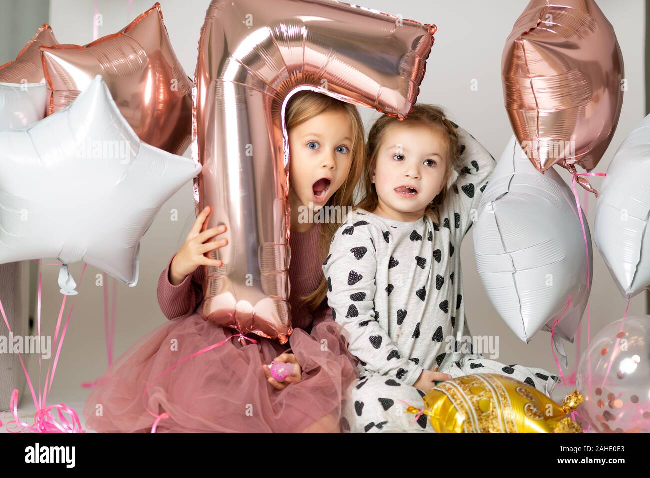Alles Gute zum Geburtstag 7 Jahr. kleine Mädchen im Abendkleid aus einem Ballon in der Form einer 7 auf weißem Hintergrund mit Perlen Stockfoto