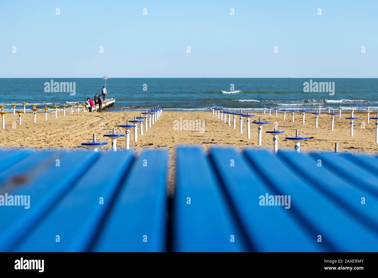 Meer aus gesehen hinter dem Steg der privaten Strand mit Sonnenschirmen Stockfoto