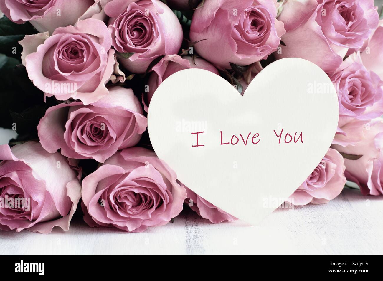 Schön retro soft pink rose Blume Hintergrund mit Holz- Herz und Text ich liebe Dich. Stockfoto