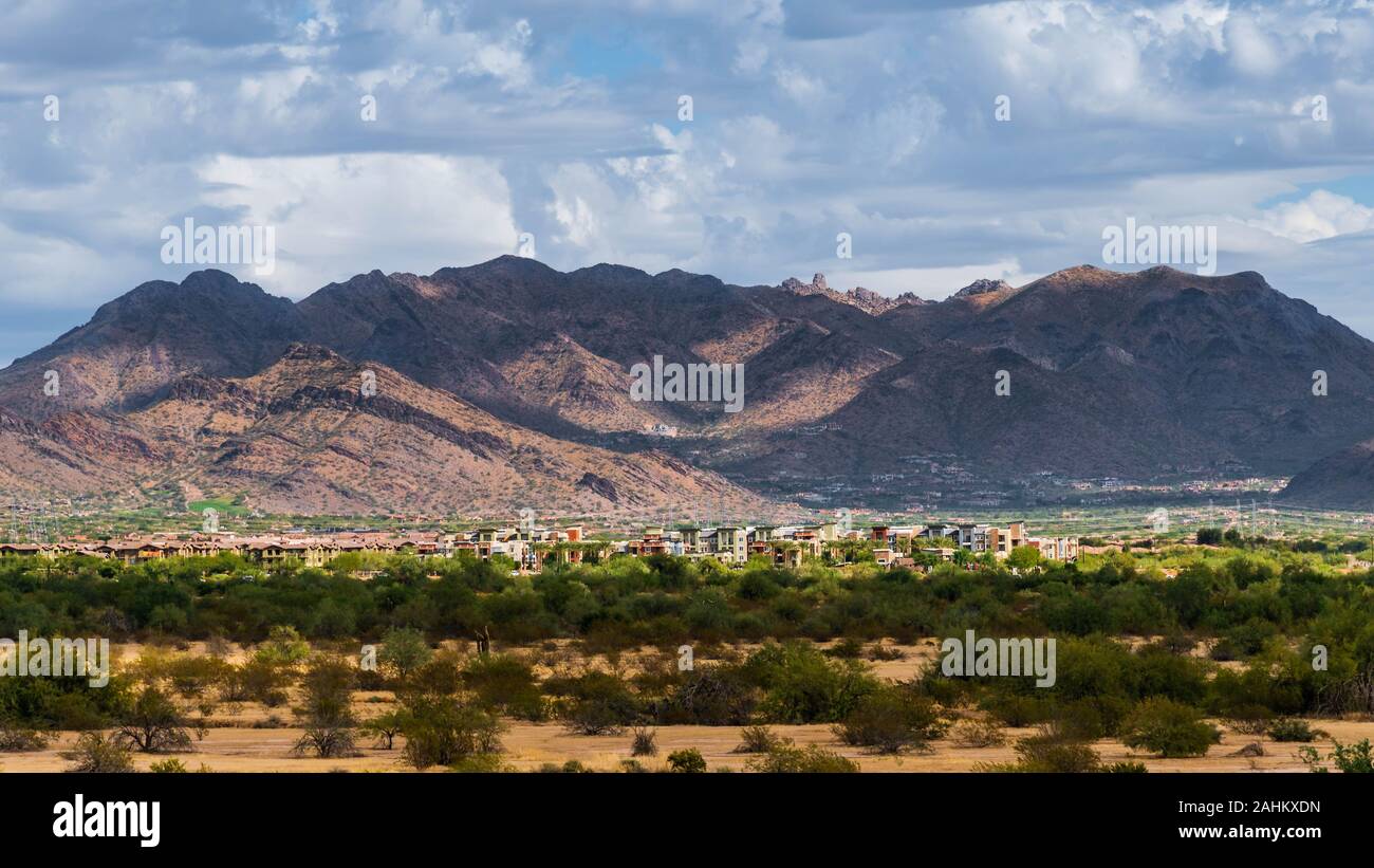 Unentwickelte Wüste und entwickeltes Land mit luxuriösen Eigentumswohnungen und Häuser in North Scottsdale mit dem McDowell Bergkette im Hintergrund. Stockfoto
