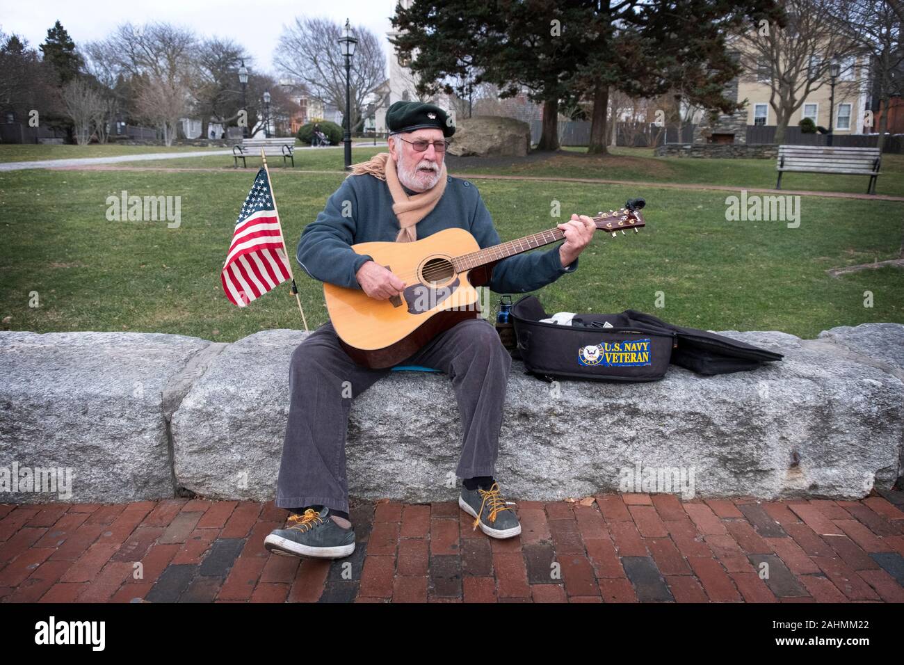 Ein Septuagenarian Vietnam Navy Veteran spielt seine Gitarre und singt auf der Thames Street in der Innenstadt von Newport, Rhode Island. Stockfoto