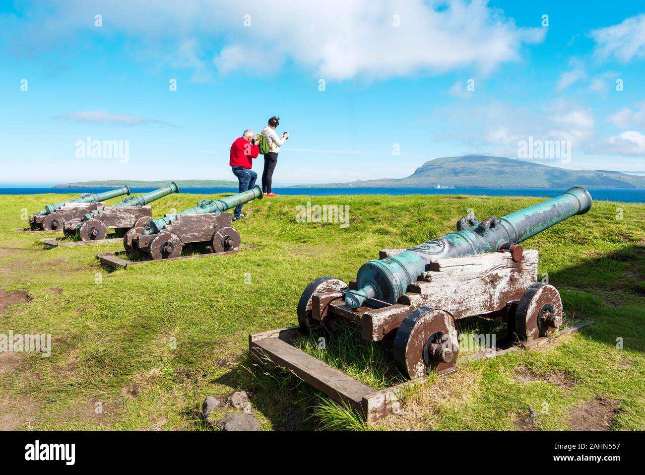 Tórshavn, Färöer - Juli 11, 2018 Touristische fotografieren Färöische Landschaft, historische Festung Skansin in Torshavn, alte Kanonen sind im Vordergrund Stockfoto