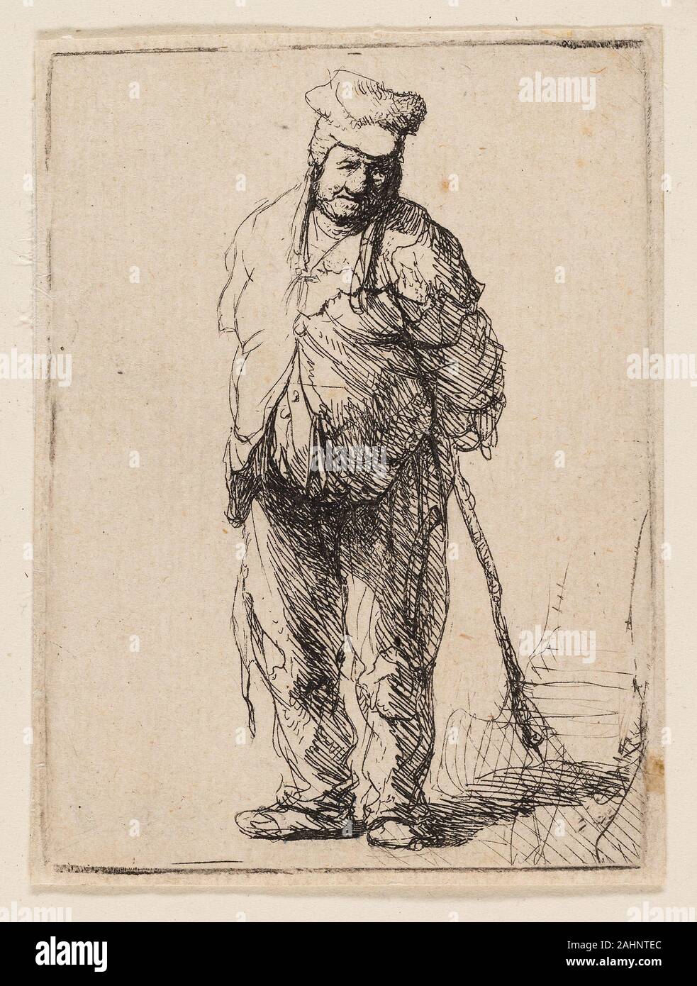 Rembrandt van Rijn. Zerlumpte Bauern mit seinen Händen hinter ihm, hält einen Stock. 1625 - 1635. Holland. Radierung auf Elfenbein Bütten Stockfoto