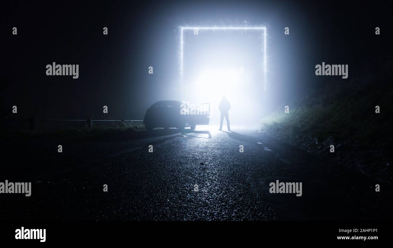 Eine glühende, Portal, Gateway auf einer Landstraße. Mit einem Mann, der neben einem Auto. Auf eine gespenstische, Nebel, winter nacht. Sceince fiction Konzept. Stockfoto