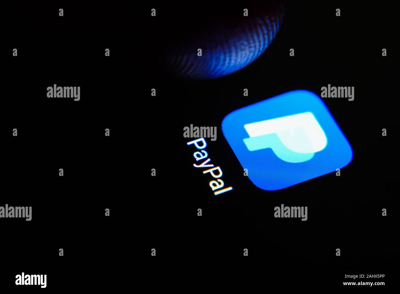 PayPal App-Symbol auf dem Smartphone-Bildschirm und Finger starten. Stockfoto
