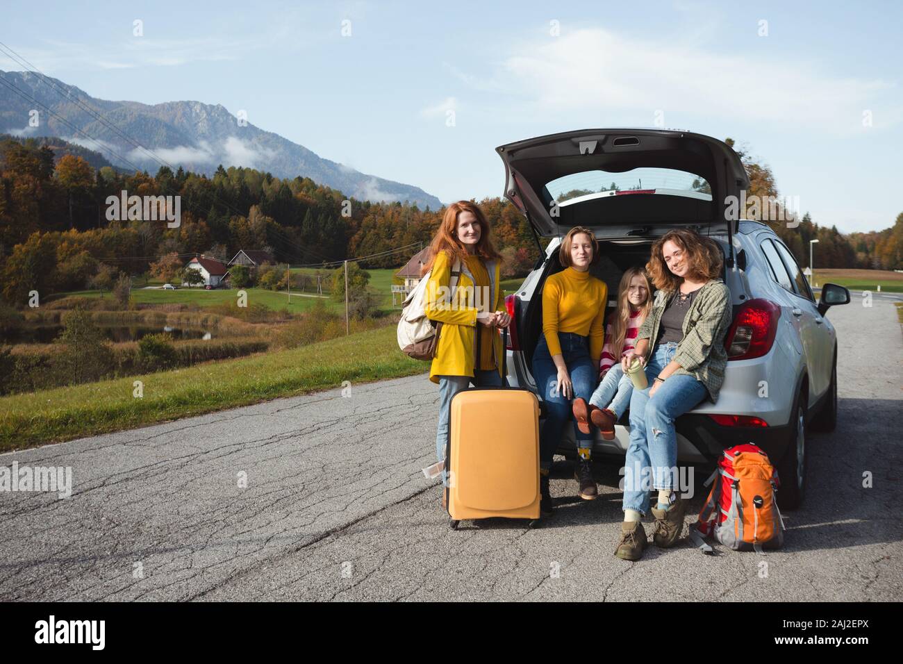 Große Familie Reise - glückliche Mädchen reisen mit dem Auto. Mamma mit Töchtern im Boot sitzen Stockfoto