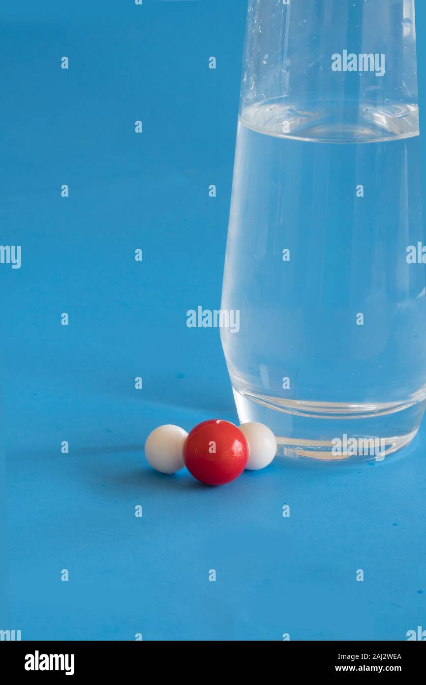Glas von flüssigem Wasser und die H2O-Molekül mit einer Wasserstoff- und zwei Sauerstoffatomen. Stockfoto