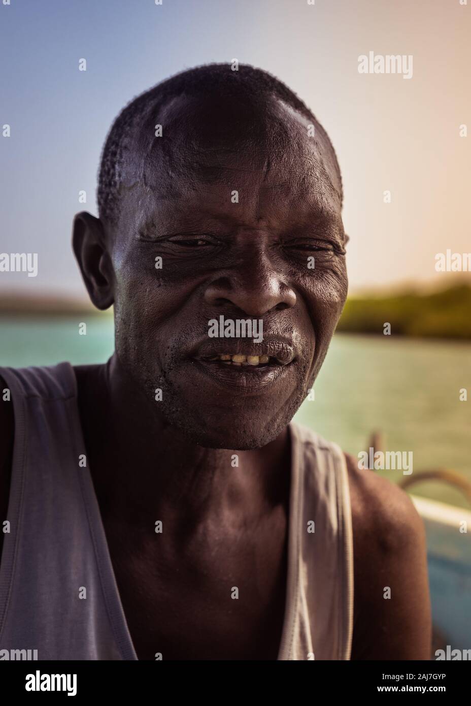 Charakteristische und verwitterten Gesicht der Riverboat Mann auf dem Boot auf dem Fluss in Saly, Senegal, Afrika - Foto: Iris de Reus Stockfoto