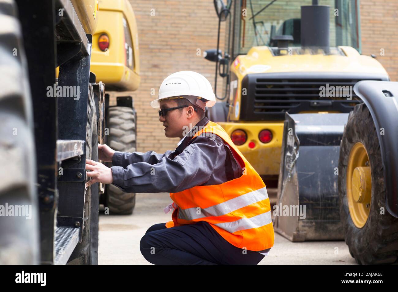 Arbeiter außerhalb der Kontrolle Reifen eines LKW Stockfoto