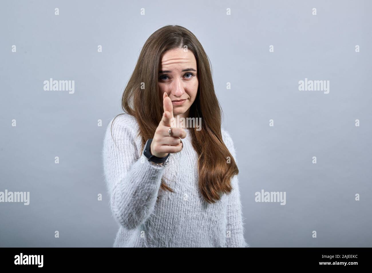 Charmante kaukasische Frau zeigt mit dem Finger auf die Kamera oder Lächeln, mit Uhr Stockfoto