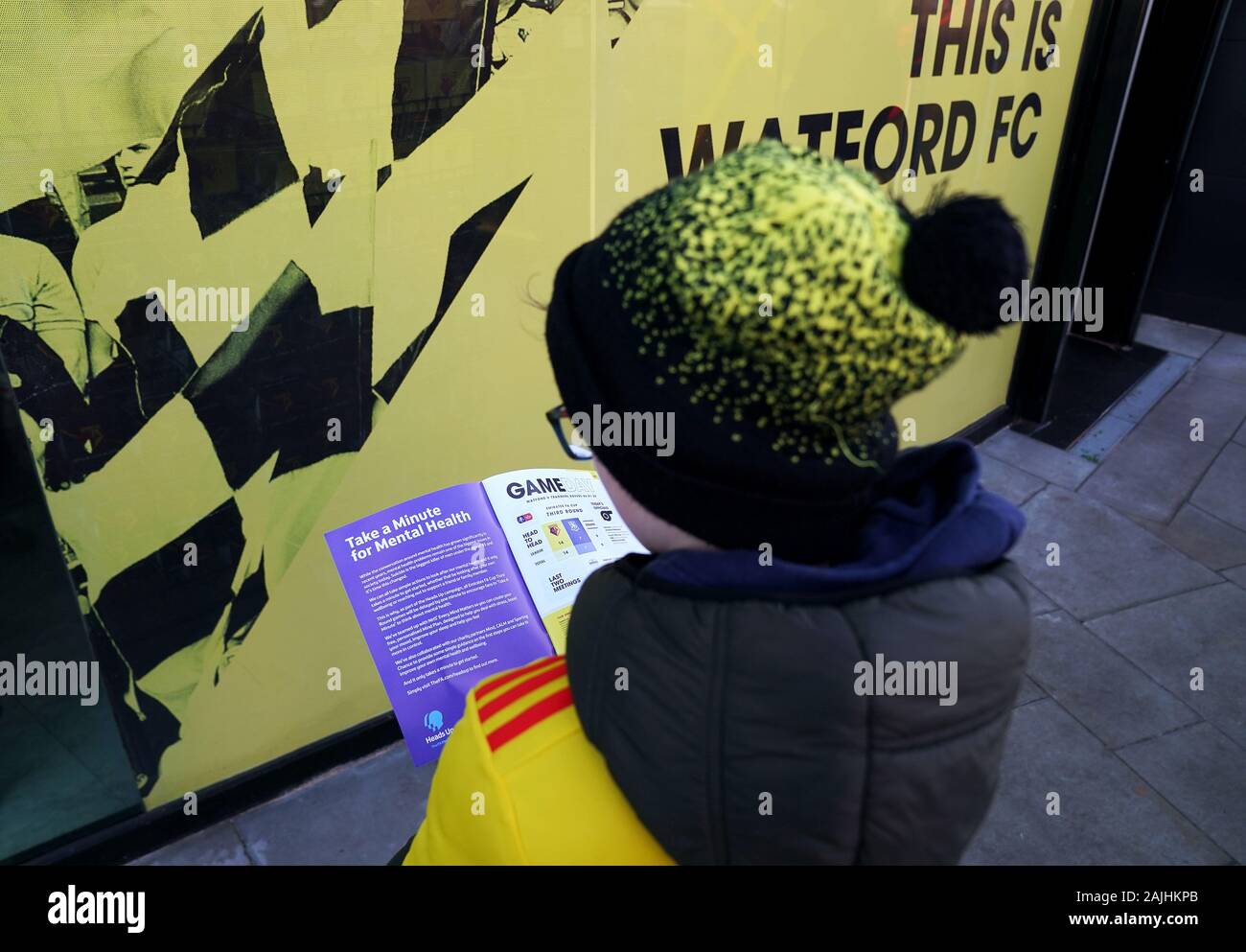 Ein Watford fan liest den Spieltag Programm mit einer Seite die Fans eine Minute für psychische Gesundheit vor dem FA Cup in der dritten Runde an der Vicarage Road, Watford zu nehmen. Stockfoto