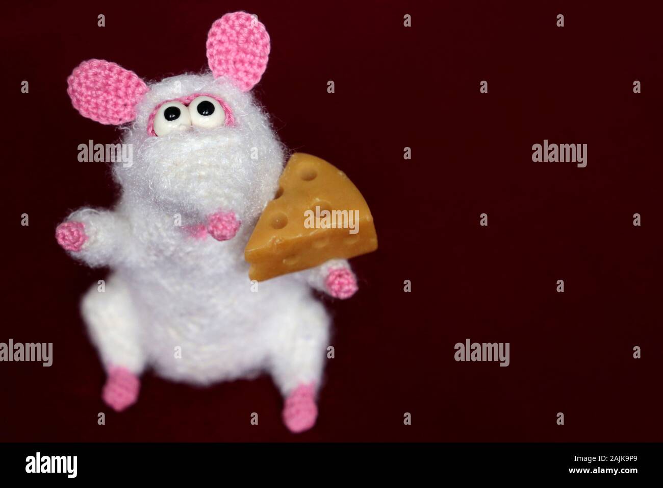 Weiß gestrickte Spielzeug Ratte mit Stück Käse auf rotem Hintergrund, neues  Jahr. Chinesische Jahr der Ratte, Sternzeichen Symbol 2020 Stockfotografie  - Alamy
