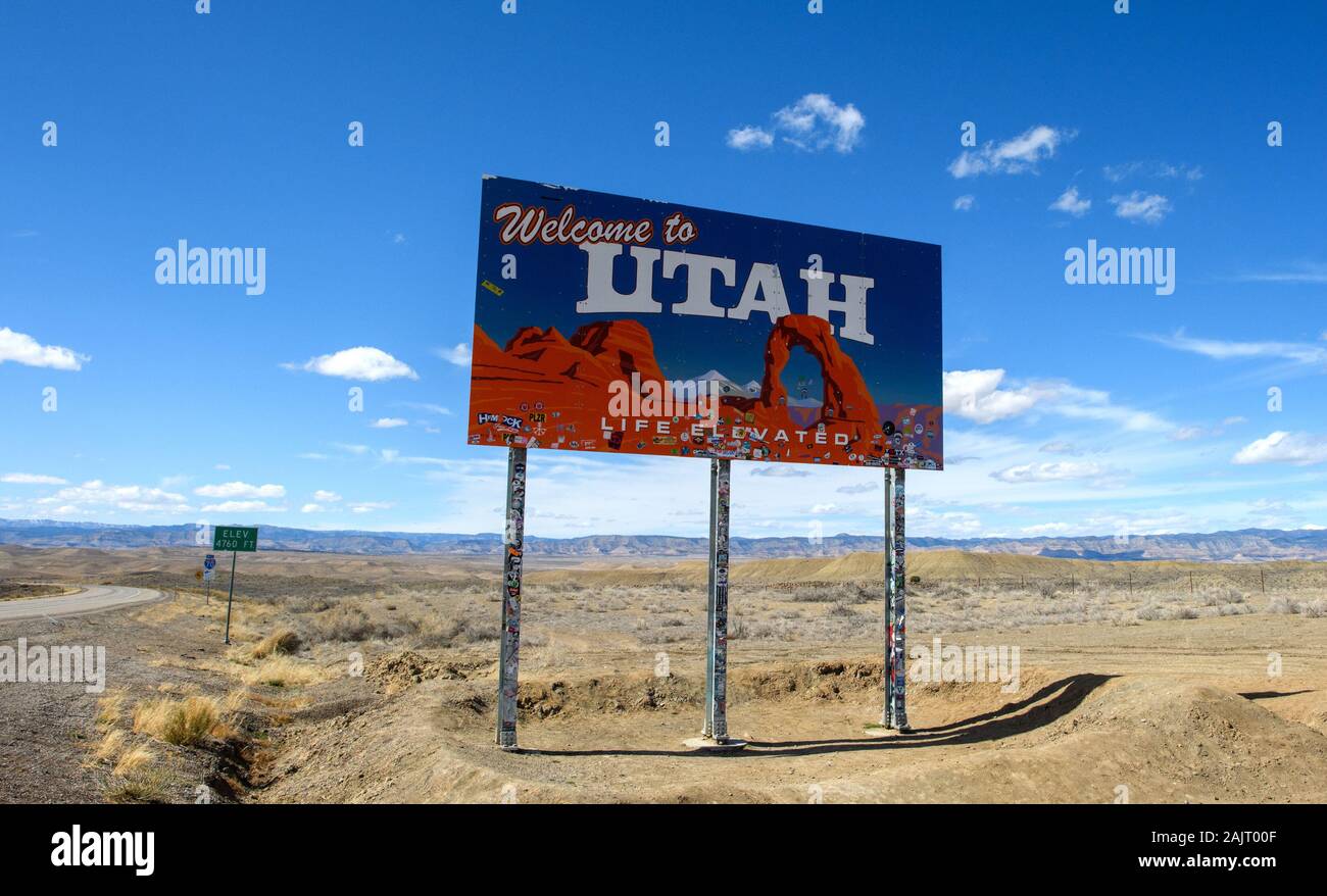 Ein Willkommen in Utah Zeichen oder ein Plakat auf der I-70 an der Utah Colorado State Line ist mit Aufklebern bedeckt. Stockfoto