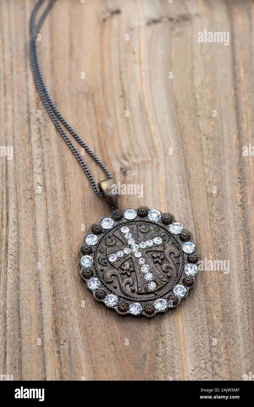 Kreuz-Anhänger auf Holz Hintergrund Stockfoto