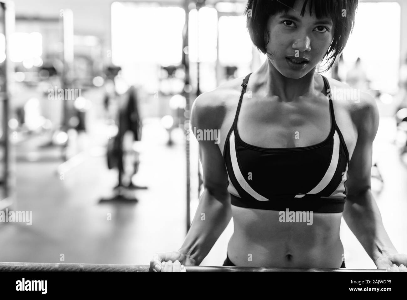 Junge schöne asiatische Frau, die an der Turnhalle arbeiten Stockfoto