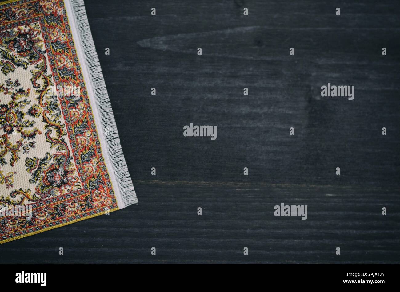 Oriental persischer Teppich auf schwarzem Holz- Hintergrund, die Dekoration. Stockfoto
