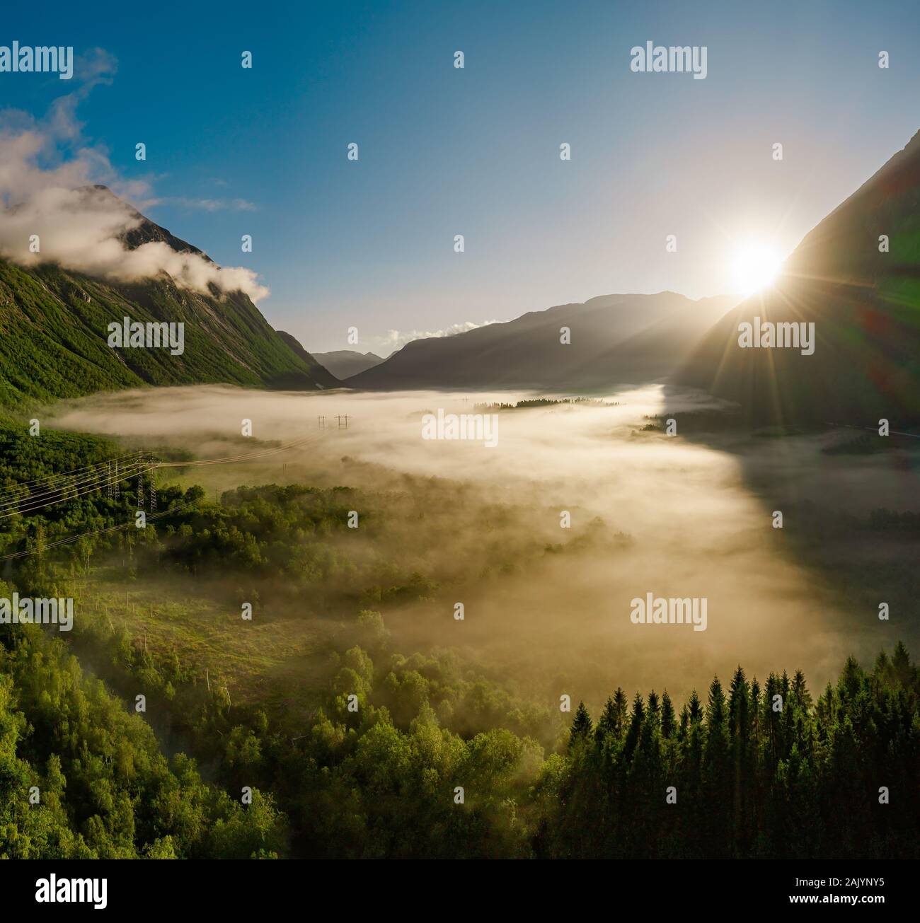 Morgennebel über dem Tal zwischen den Bergen im Sonnenlicht. Nebel und schöne Natur Norwegen Luftaufnahmen. Stockfoto