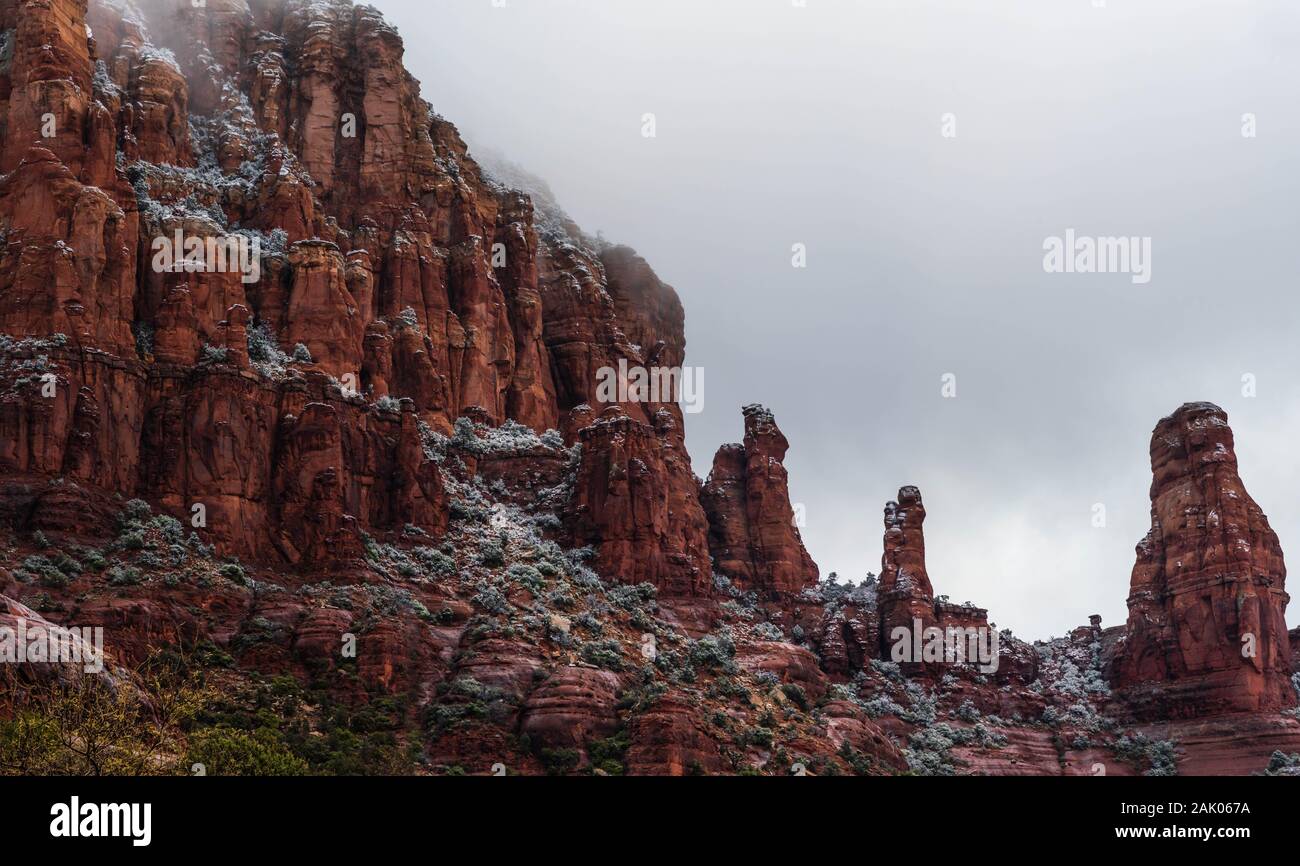 Nebel steigt aus einem Schnebly Hill Bildung, Sedona Red Rock Bergen, im Arizona an einem kalten Wintermorgen mit bewölktem Himmel. Stockfoto